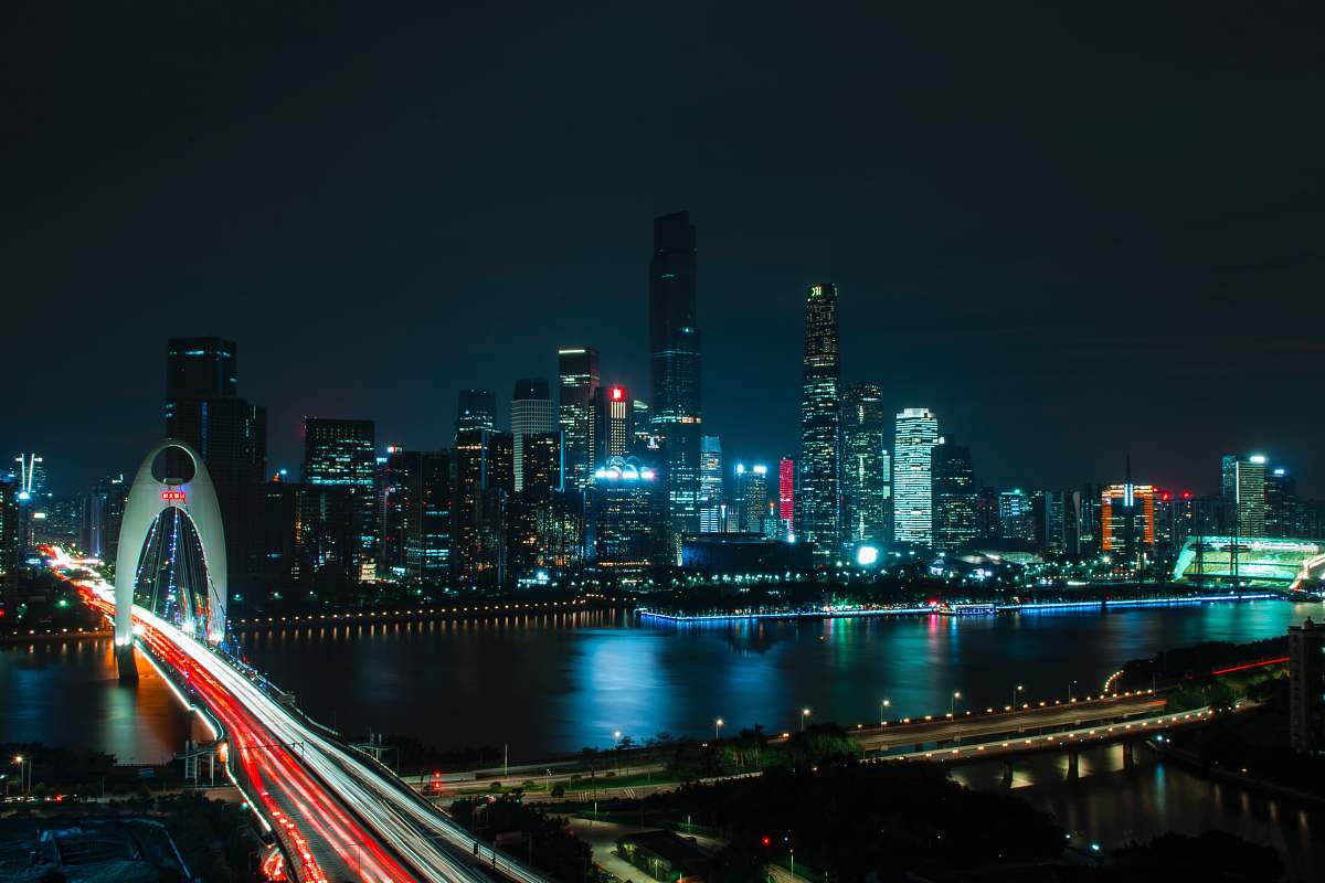 long exposure landscape photography of bridge near high-rise buildings city at night